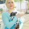 Bambi Thacker poses as Olaf with Elsa. Both characters are from Disney's Frozen.